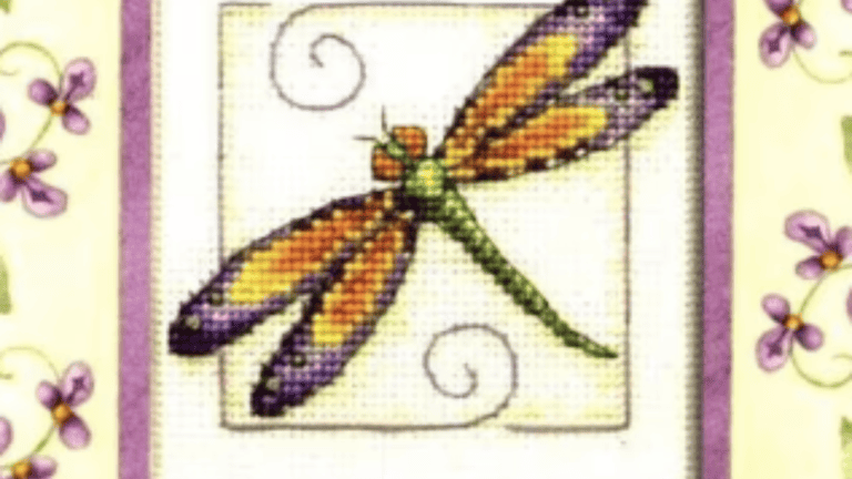 A purple and green and orange dragonfly with a few additions